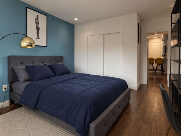 Primary bedroom with built-in closet storage — modern Little Italy NYC apartment rental"