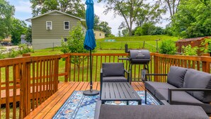 A wooden deck with outdoor furniture, a grill, and a blue umbrella. - Wheels Trails and Tails Inn - Fully Fenced! 2x King 2x Twin Pet Friendly (Boonville)