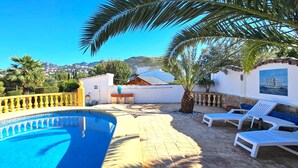 A swimming pool with a yellow balustrade, lounge chairs, and a view of the surrounding landscape. - Villa LOS JAZMINES at Monte Pego (Pego)