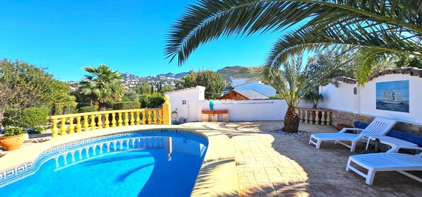 A swimming pool with a yellow balustrade, lounge chairs, and a view of the surrounding landscape. - Villa LOS JAZMINES at Monte Pego (Pego)