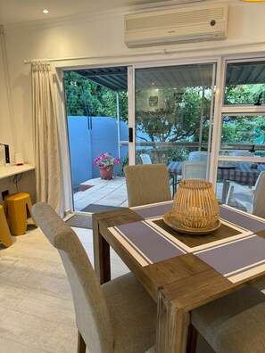Enjoy meals in this dining area with a table for two, comfortable chairs, and a woven basket centerpiece.