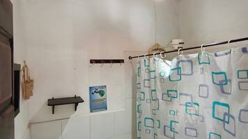 A bathroom with a sink, toilet, and shower curtain.