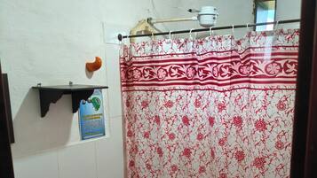 A bathroom with a toilet, sink, and shower curtain.