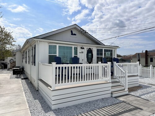 Relax here with beach views, steps to the beach, fenced in yard, pet friendly