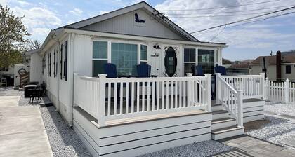 Relax here with beach views, steps to the beach, fenced in yard, pet friendly