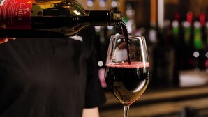 A bottle of wine being poured into a glass. - Bar Broadway (Chippendale)