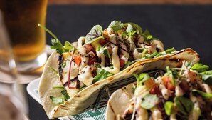 A plate of tacos with a glass of beer on the side. - Unanderra Hotel  (Unanderra)