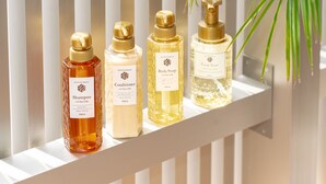 Four bottles of shower products on a white shelf. - QUEENDOM KARATSU HOTEL (Karatsu)