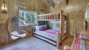 A rustic wooden room with a bunk bed, a hanging chair, and a chandelier. - Chic Lake Arrowhead Retreat: 4 Seasons of Fun! (Lake Arrowhead)