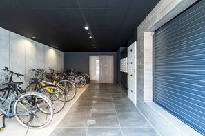 Bicycles are neatly arranged in a secure storage area with designated parking spaces.