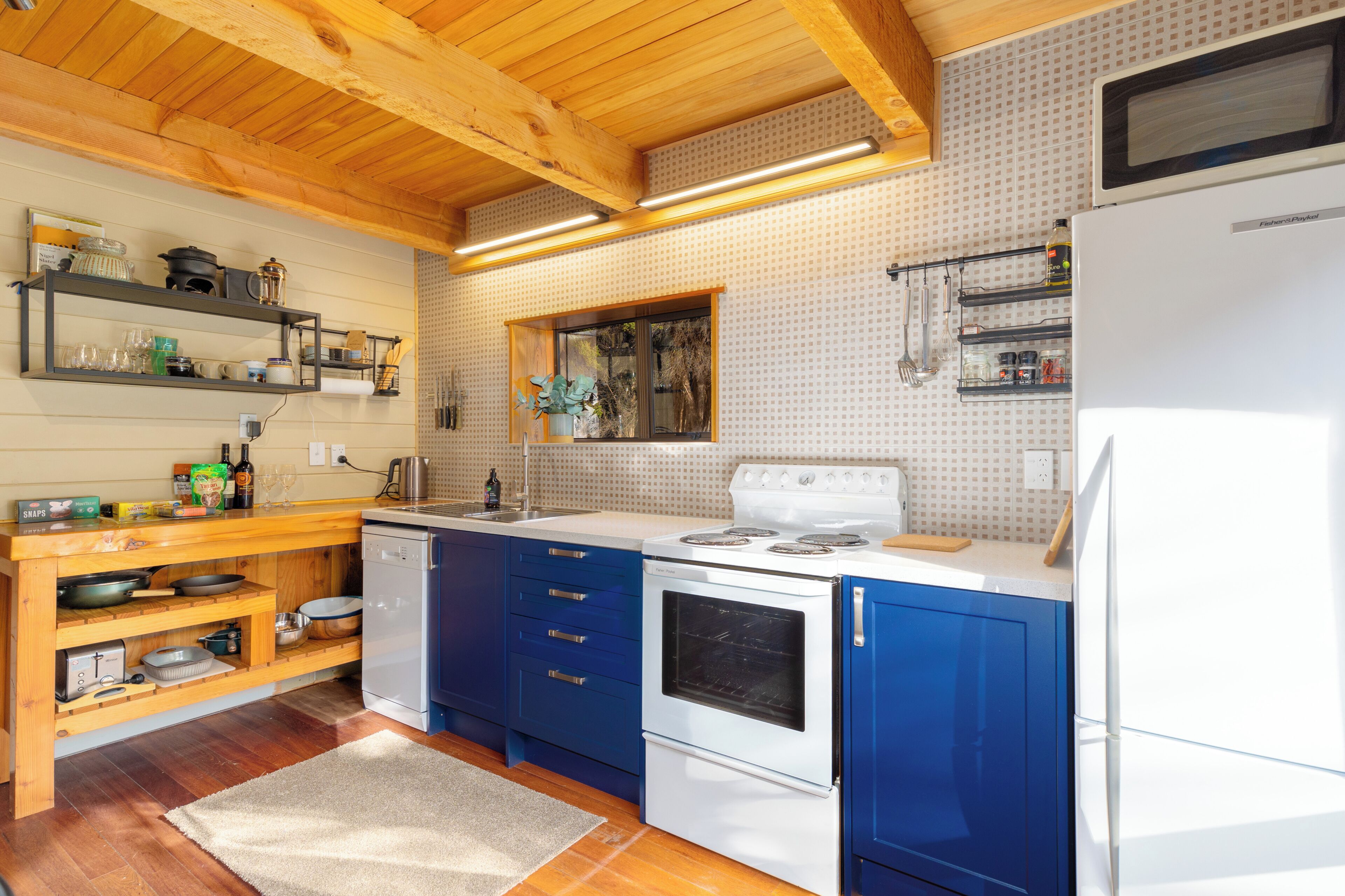 A kitchen with wooden cabinets, a white stove, and a refrigerator.