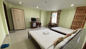 A hotel room with two beds, a desk with a computer, a wardrobe, and a window with curtains. - Hoang Tay 1 Hotel by Bay Luxury (Ho Chi Minh City)