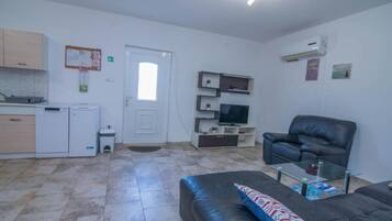 Apartment (Apartment with Balcony) | Living room | 32-inch flat-screen TV with satellite channels