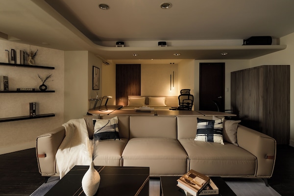 Stylish Living Area:
• 65" TV w/ MOD
• Sofa
• Coffee Tables
• Natural Light
