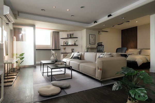 Stylish Living Area:
• 65" TV w/ MOD
• Sofa
• Coffee Tables
• Natural Light