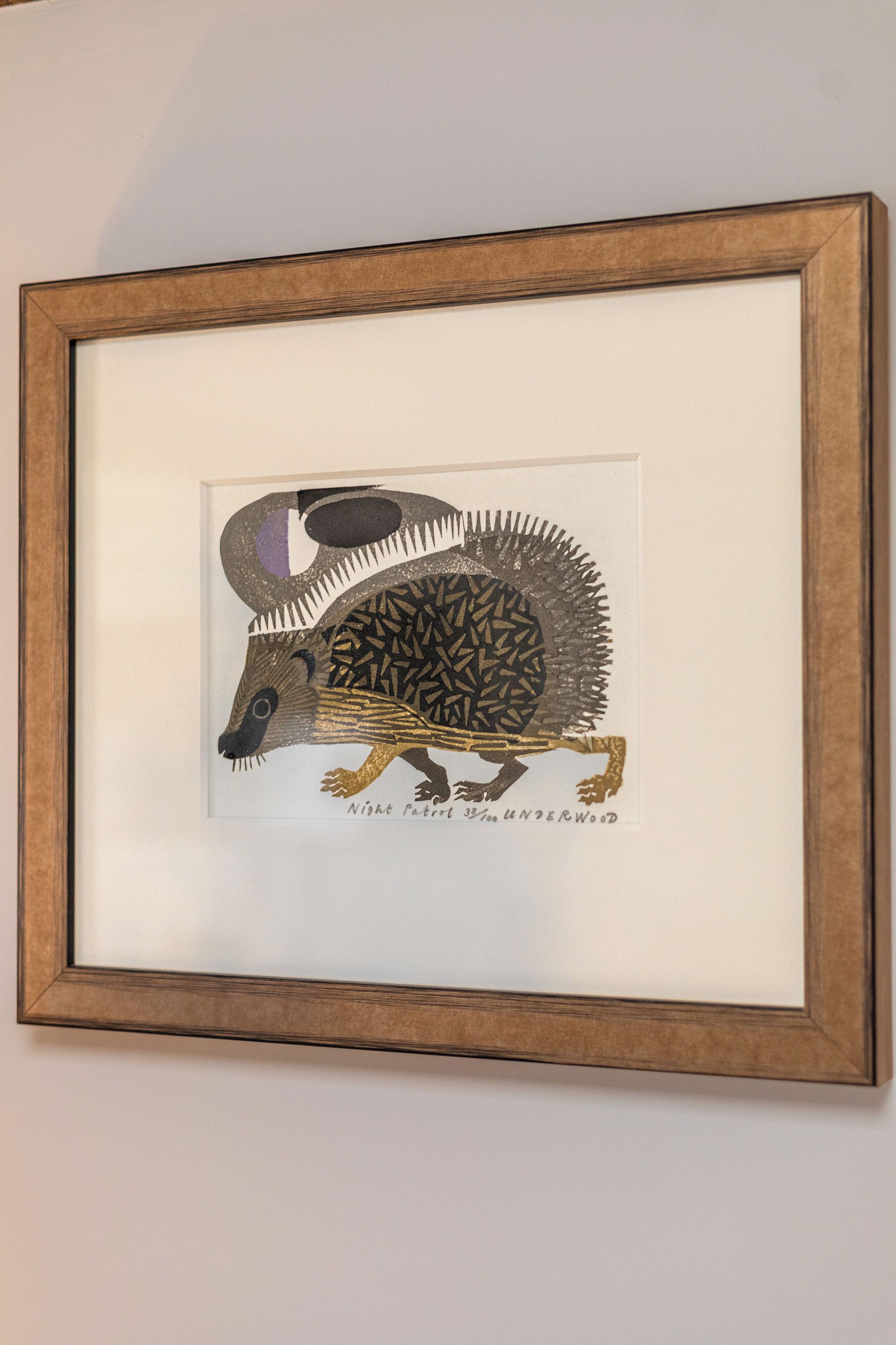 A framed artwork of a hedgehog.