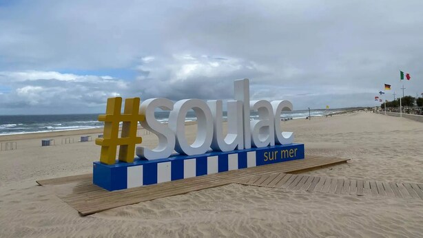 A beach sign with the word "SOU" and "sur mer" indicating a French beach.