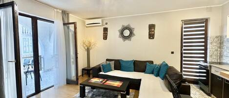 Standard Apartment | Living area | 32-inch LCD TV with cable channels