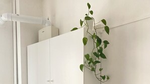 A kitchen with white cabinets, a sink, a dish rack, a refrigerator, and a potted plant. - Apartment in Alba with free parking. Sleeps 7. Self check-in (Alba)