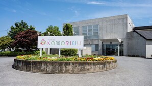 A modern building with a sign for Hotel KOMORINU. - Satonuma Resort Hotel Komorinu (Tatebayashi)