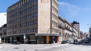 A large, multi-story hotel with a modern facade, located at a city intersection. - STAYSOME Porto Herculano (Porto)