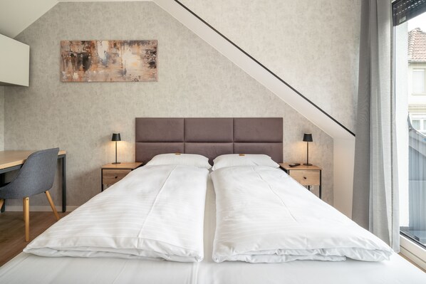 Une chambre moderne avec un lit en mezzanine, un bureau et une chaise.
