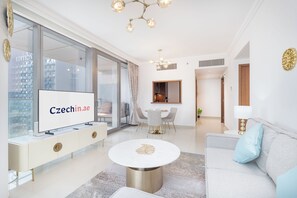 Elite Apartment, Balcony, City View | Living area | 50-inch Smart TV with cable channels