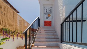 A staircase with a white door, a basketball hoop, and a door number. - Das Hotel (Çesme)