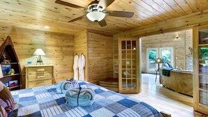 A wooden cabin room with a bed, a desk, a chair, and a ceiling fan. - Scenic Mountain Cabin w/ Hot Tub & Fire Pit (Blue Ridge)