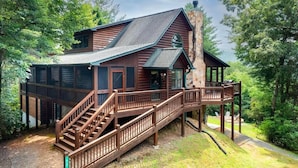 A log cabin with a wooden deck and stairs leading to a porch. - Scenic Mountain Cabin w/ Hot Tub & Fire Pit (Blue Ridge)