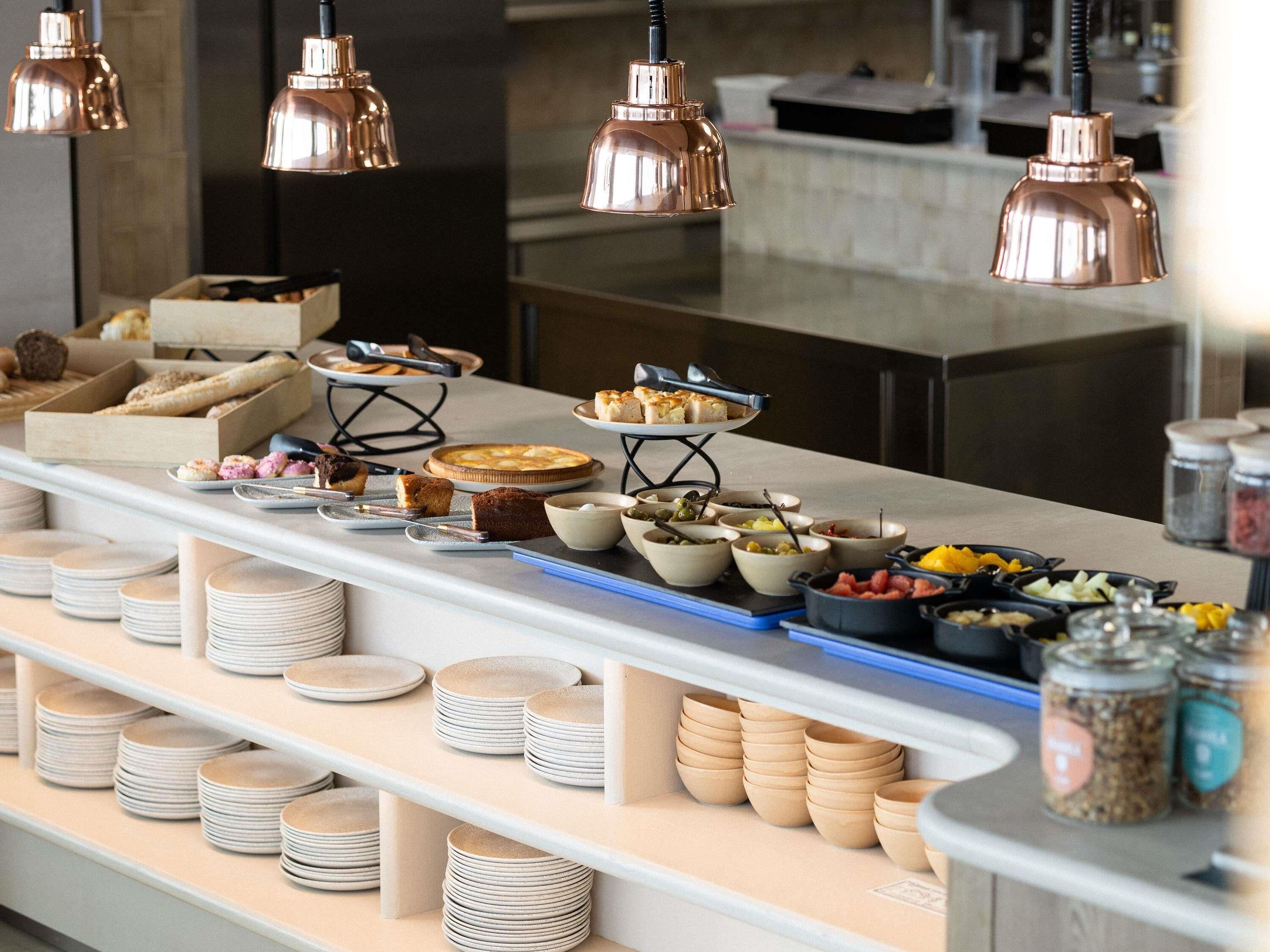 Una mesa de buffet con diferentes alimentos y utensilios.