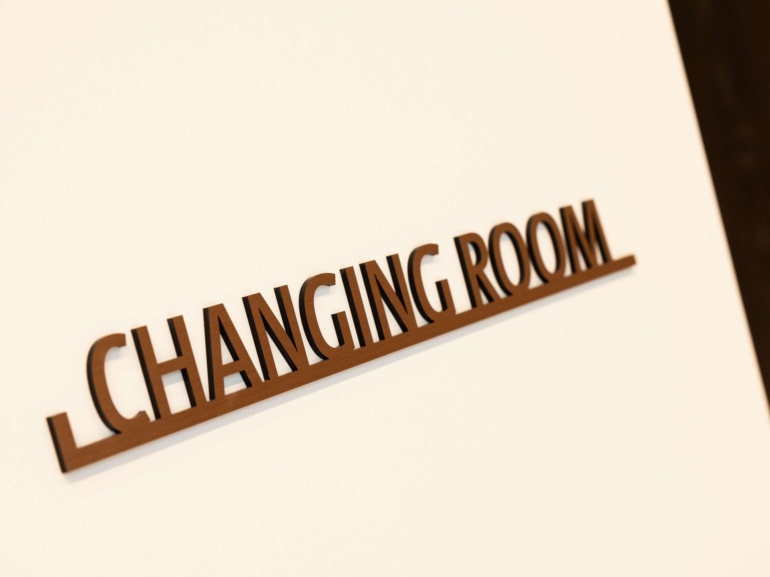 A sign with the text 'CHANGING ROOM' indicating a room designated for changing clothes.