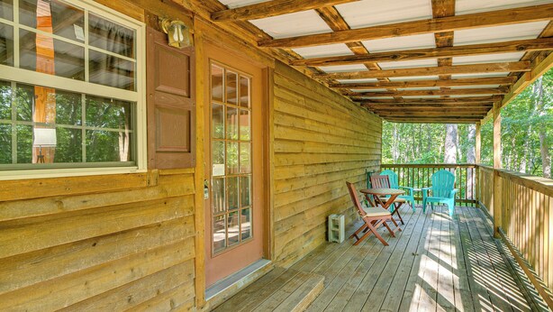 A wooden cabin with a porch, a door with glass panels, and outdoor seating. - Clarkson Cabin - 17 Mi to Mammoth Cave Natl Park! (Clarkson)
