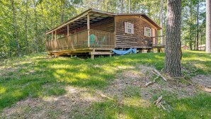 A rustic cabin with a porch, surrounded by trees. - Clarkson Cabin - 17 Mi to Mammoth Cave Natl Park! (Clarkson)