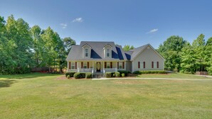 A two-story house with a front porch, a well-maintained lawn, and a large driveway. - Unicoi Wine Trail Retreat! Bbq-ready Deck w/ Views (Sautee Nacoochee)
