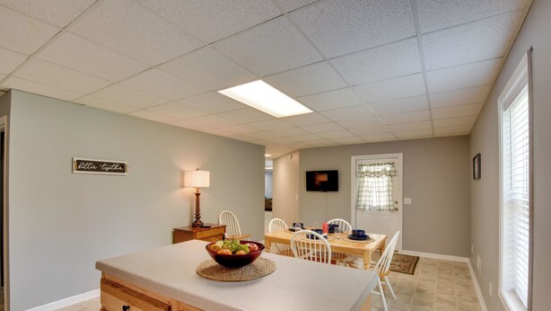A kitchen with a wooden countertop, a bowl of fruit, and a dining area with chairs and a table. - Wine Trail Apt 7 Mi to Yonah Mtn! Patio & Views (Sautee Nacoochee)