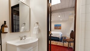 Ein Badezimmer mit Waschbecken, Spiegel und Handtuchhalter.