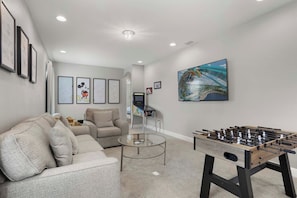 Loft area with a foosball table, smart tv and kids play area - 6BR Pool Home near Theme Parks & Disney (Kissimmee)