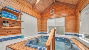 A wooden cabin with a hot tub, wooden shelves with towels, and a sign with swimming instructions. - Beautiful multi-level oceanfront home, perfect retreat for friends or family. (Seaside)
