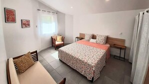 A bedroom with a bed, a chair, a nightstand, and a window with curtains. - Bed &breakfast in a peaceful natural setting swimming pool guaranteed relaxation (Dauphin)
