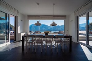 Enjoy meals with a breathtaking mountain view from this spacious dining area with a large table and comfortable seating.
