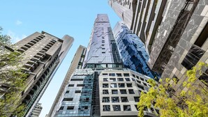A high-rise building with multiple floors, large windows, and a modern architectural design.