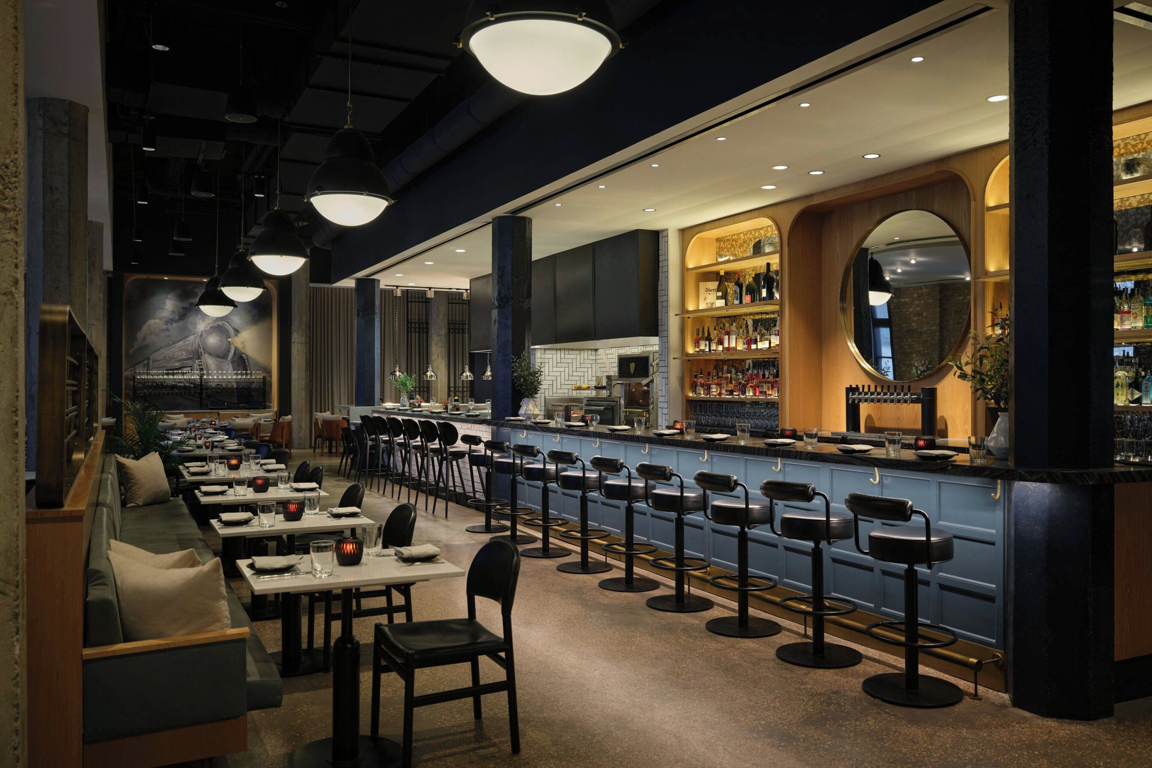 A restaurant with a bar area, seating, and a decorative mural.