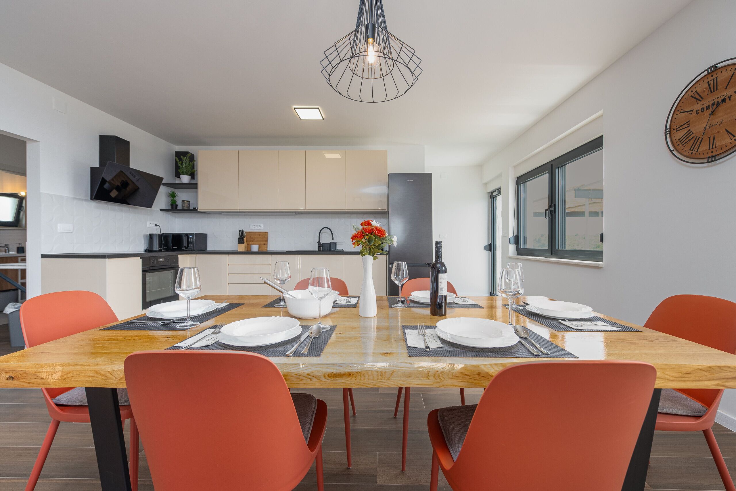 A modern kitchen with a dining area.