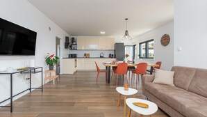 Un espacio habitable moderno con cocina, comedor y sofá.