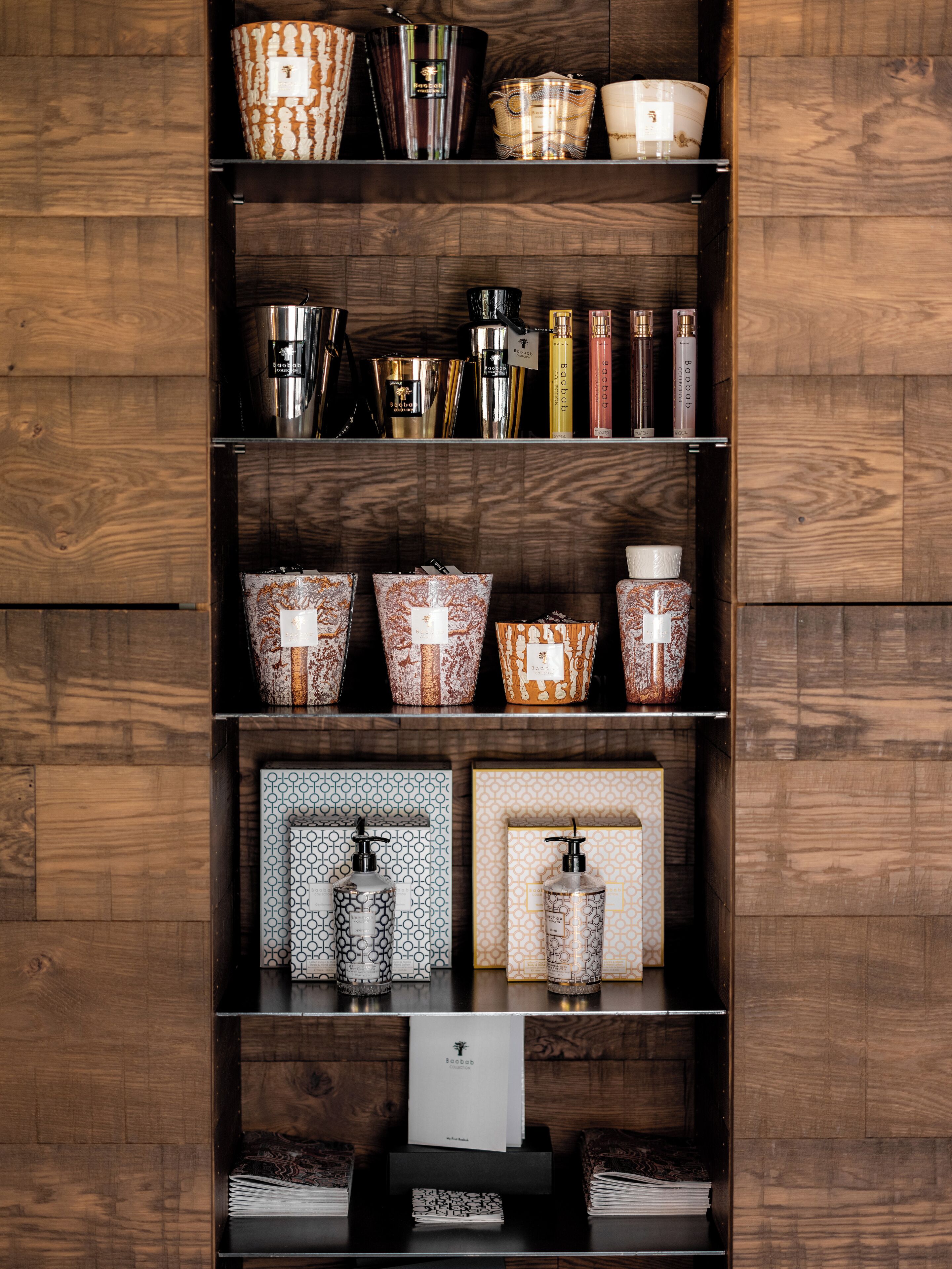 A wooden shelf with various toiletries and a book.
