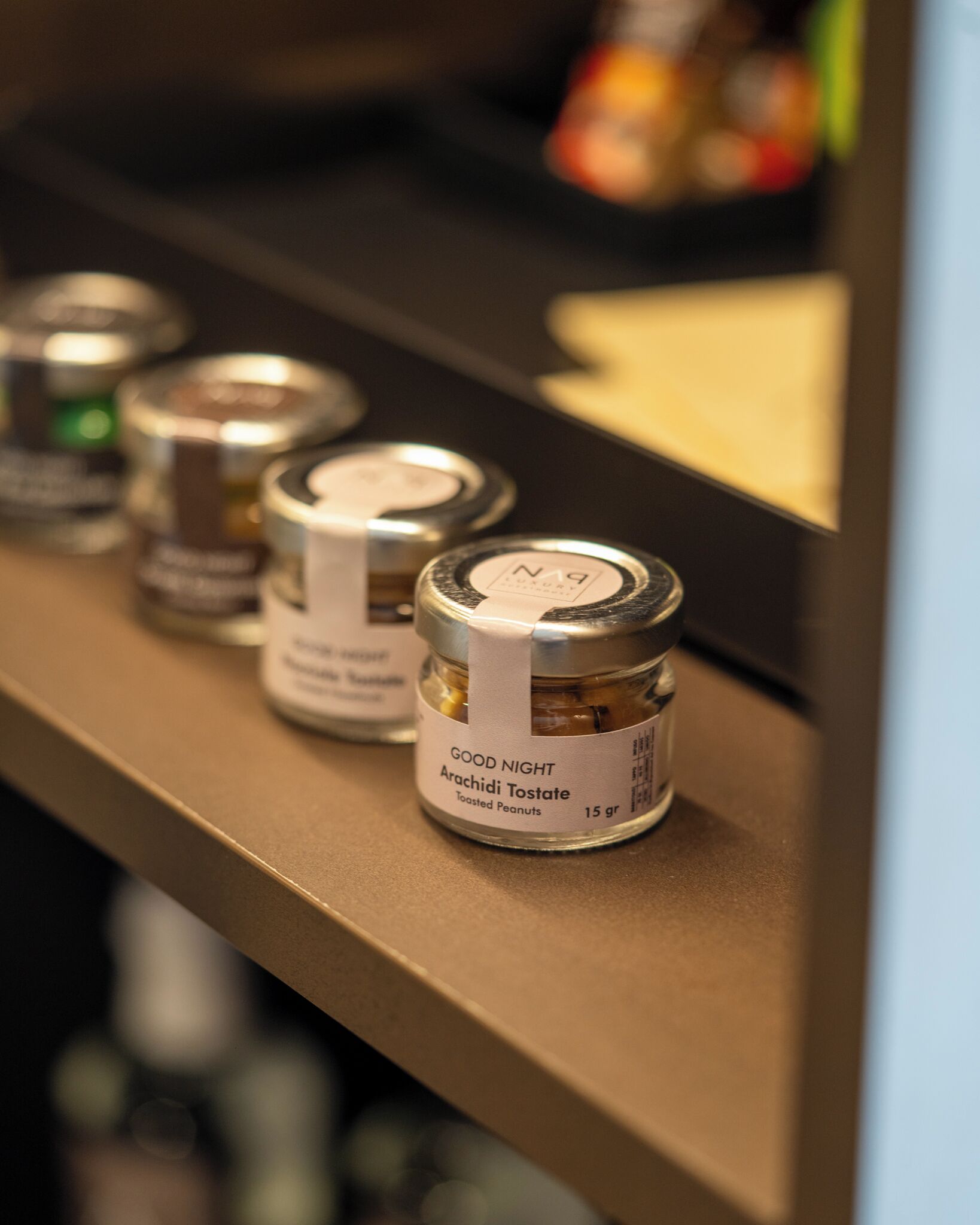 A shelf with jars of Good Night Arachidi Toastate.