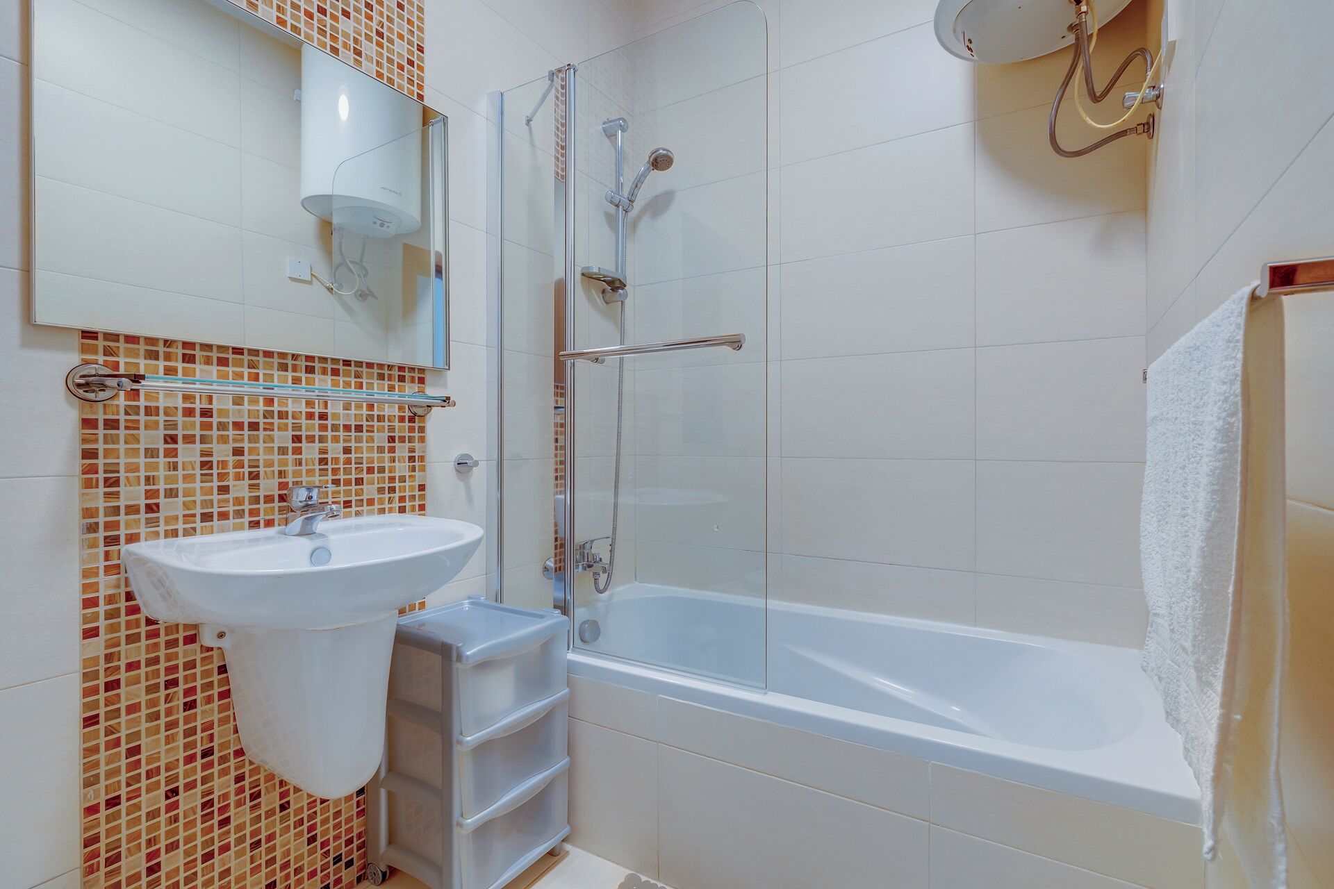 A modern bathroom with a glass-enclosed shower, a white sink, and a bathtub.