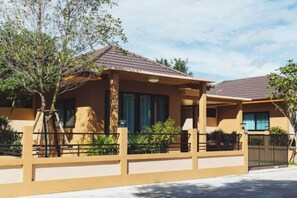 A two-story residential building with a covered porch, a fenced yard, and a clear sky. - Baan Nern Khao Resort Pattaya (Pattaya)