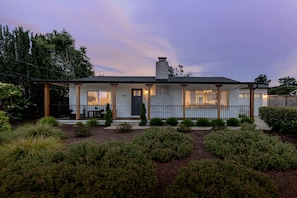 A two-story house with a front porch, a chimney, and a well-maintained garden. - Monterey Bay Ocean Peak Home Near Carmel & Pebble Beach 4 Bed 3.5 Bath & AC (Del Rey Oaks)